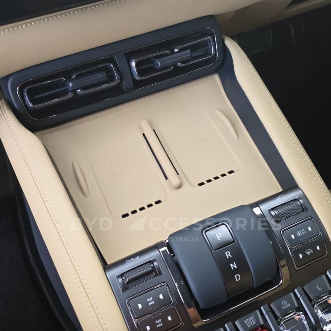 DENZA B5 Car console charging mat in sandstone with control buttons and a cup holder in a beige interior.