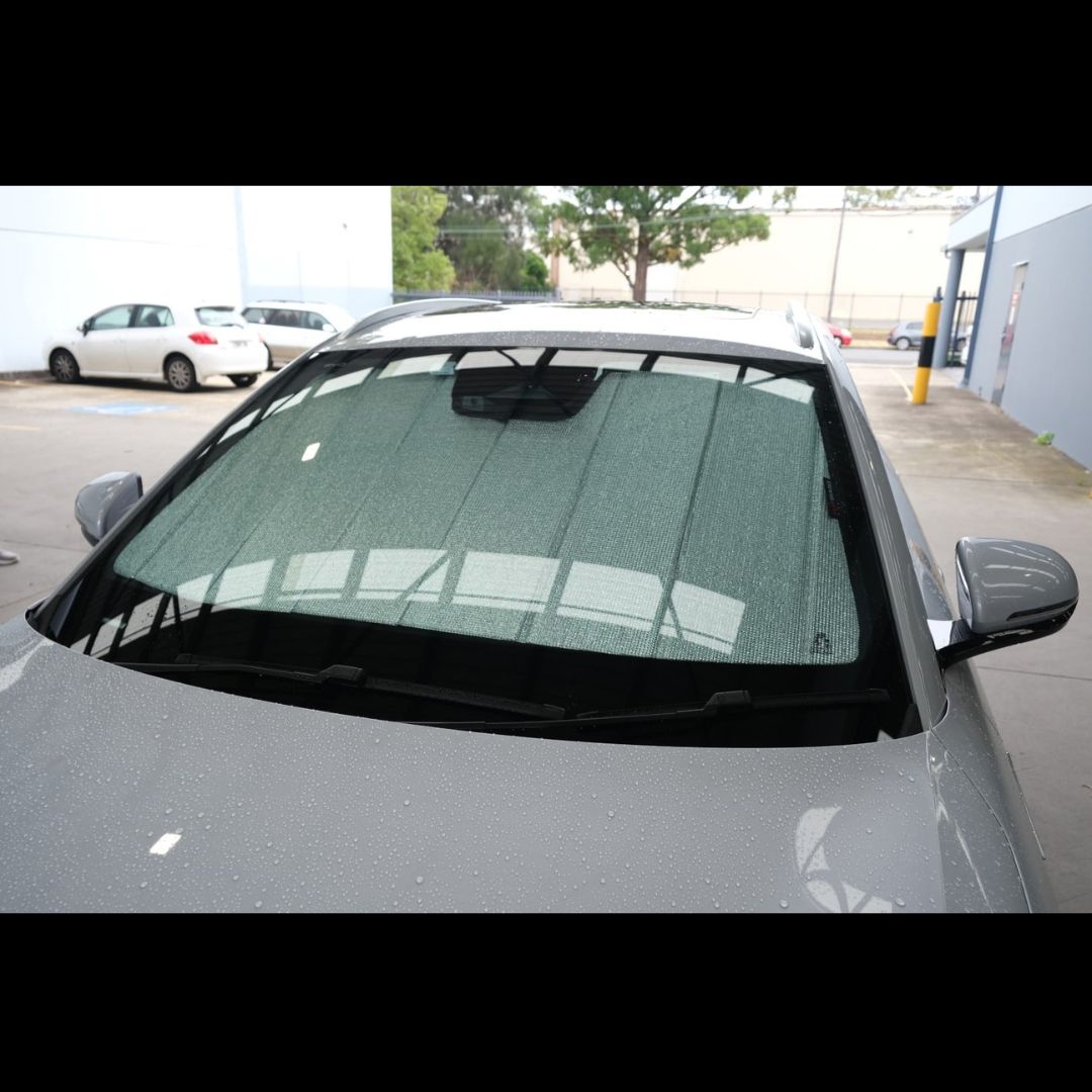 BYD ATTO 3 with a sunshade covering the windshield in an outdoor setting